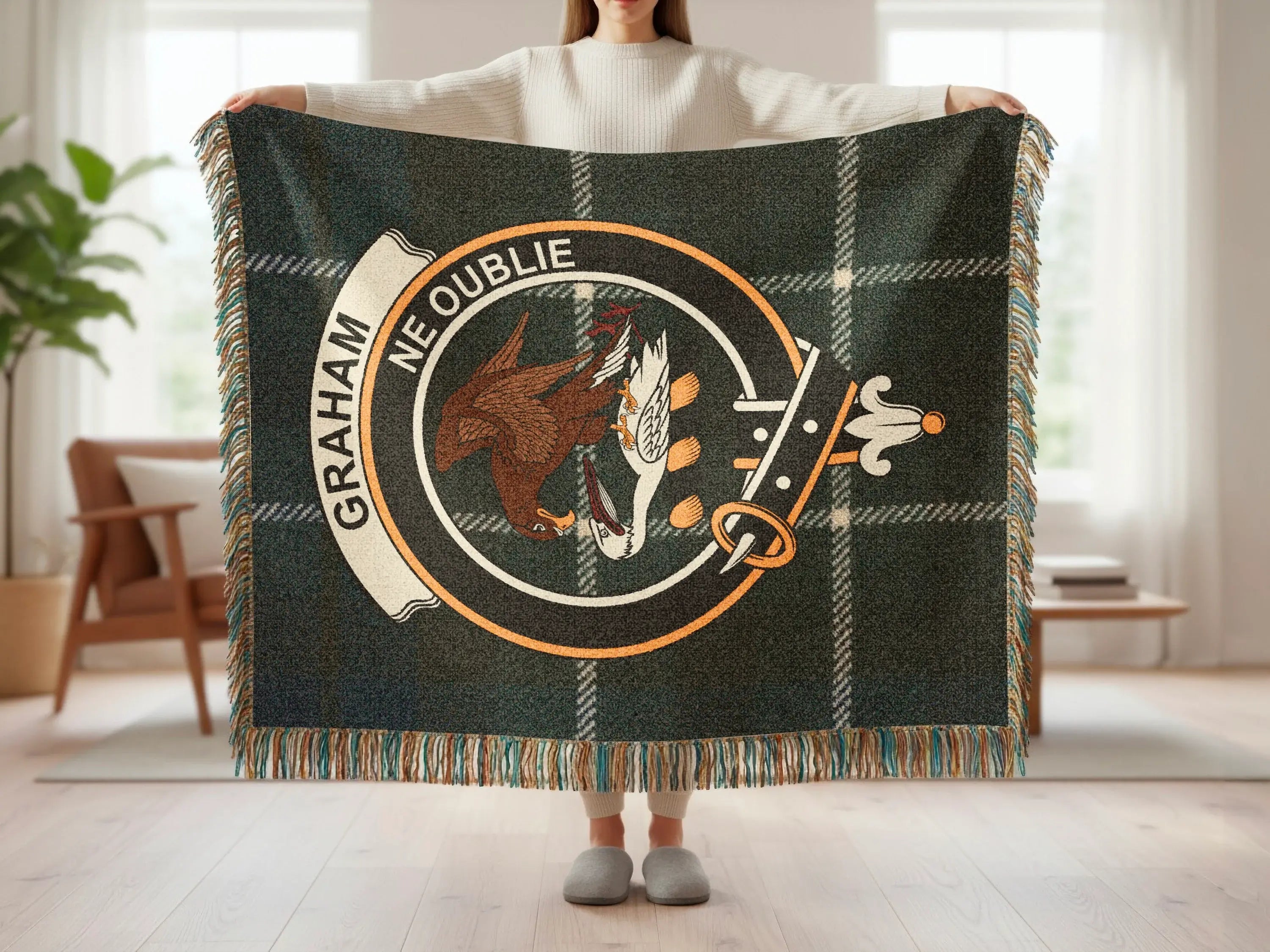 Graham Ne Oublie woven blanket flat lay — blue green and black tartan with clan crest panel