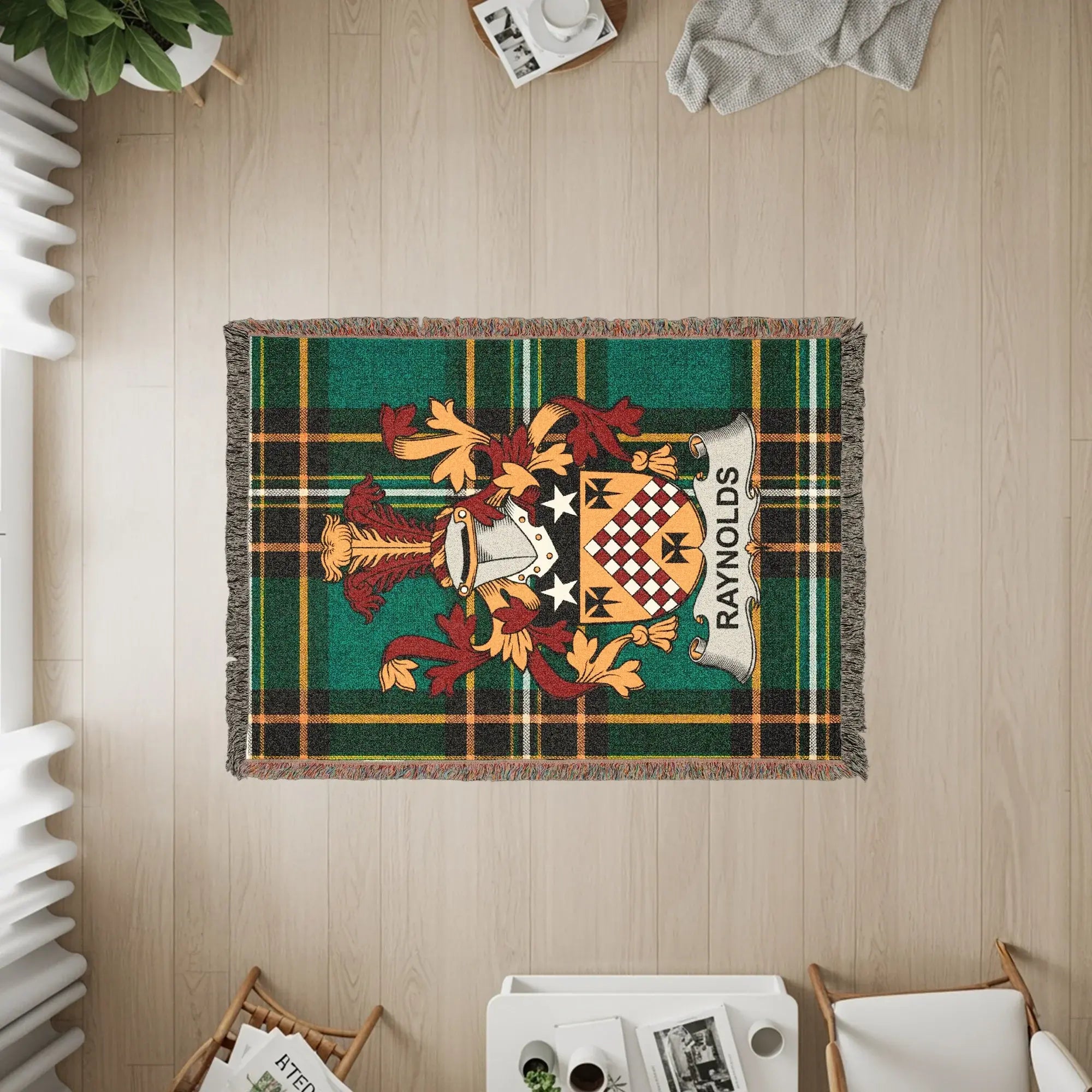 Green and gold tartan blanket with Reynolds family crest.