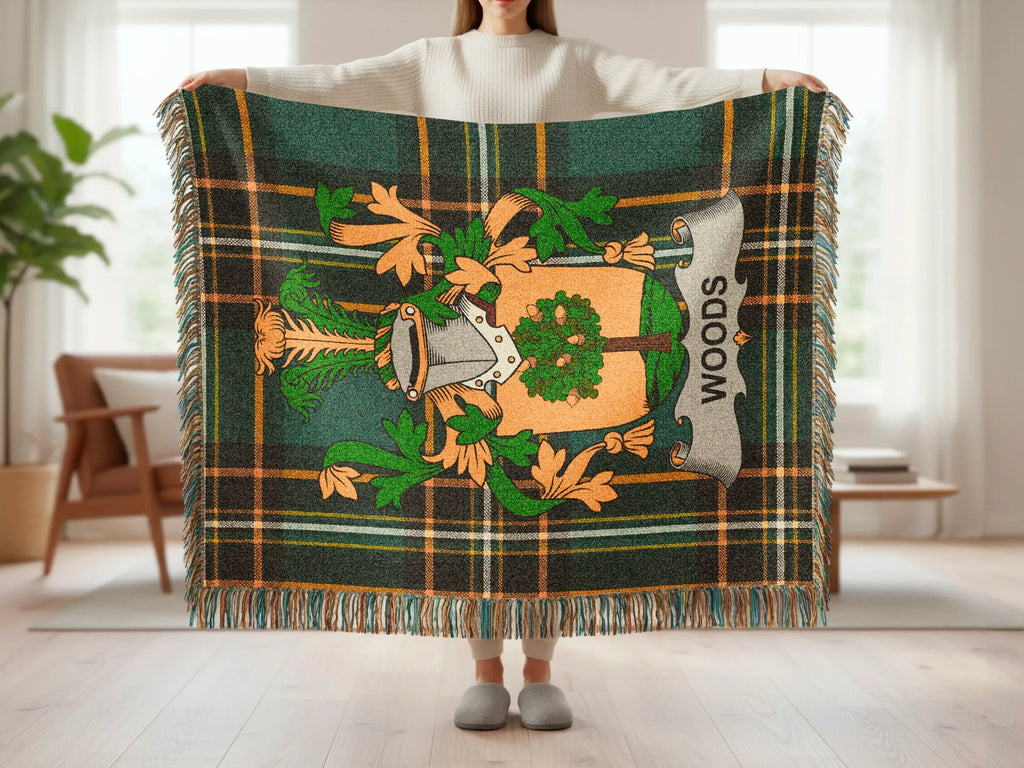 Green plaid throw blanket with a family crest and "WOODS" text.