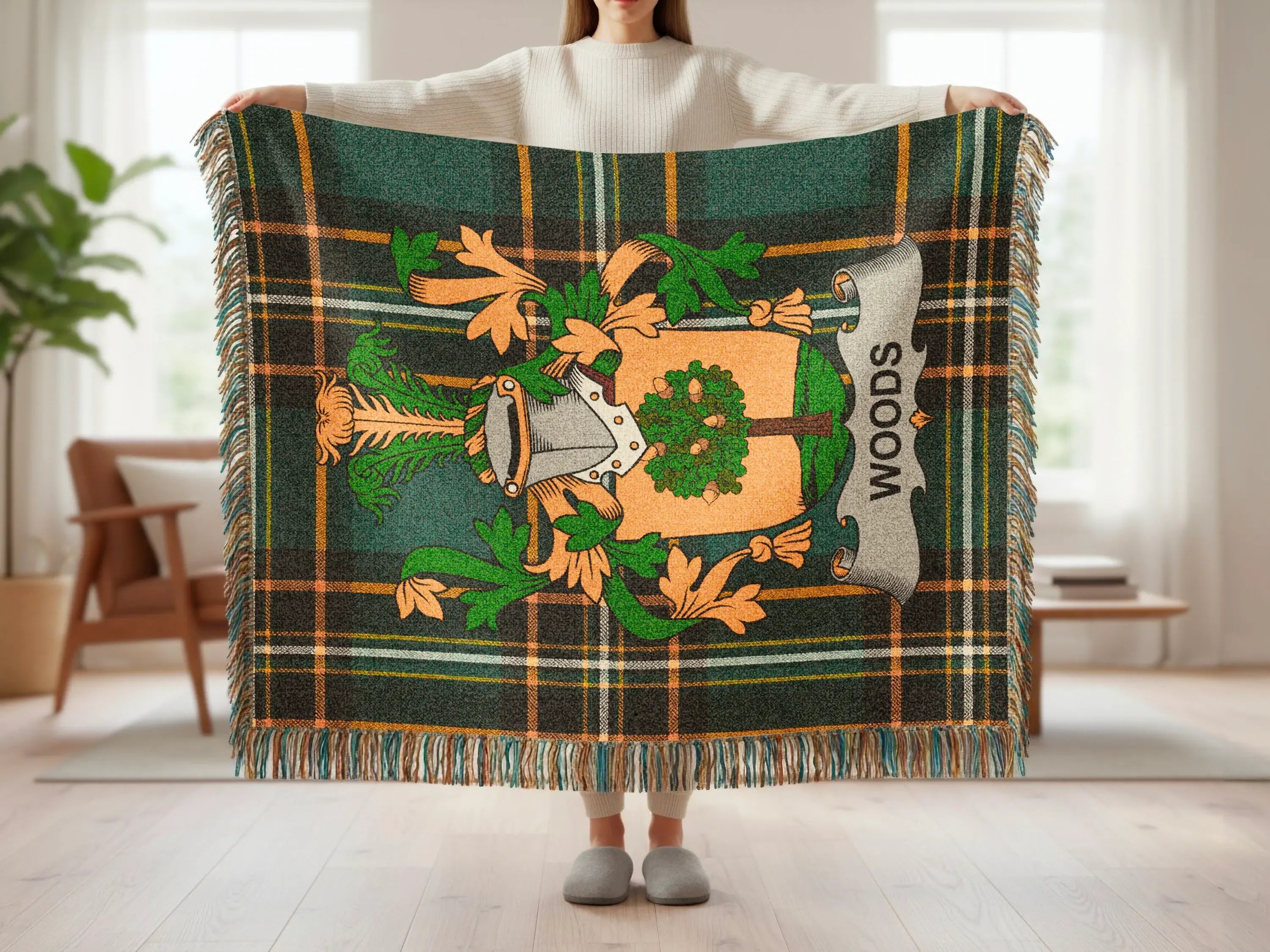 Green plaid throw blanket with a family crest and "WOODS" text.