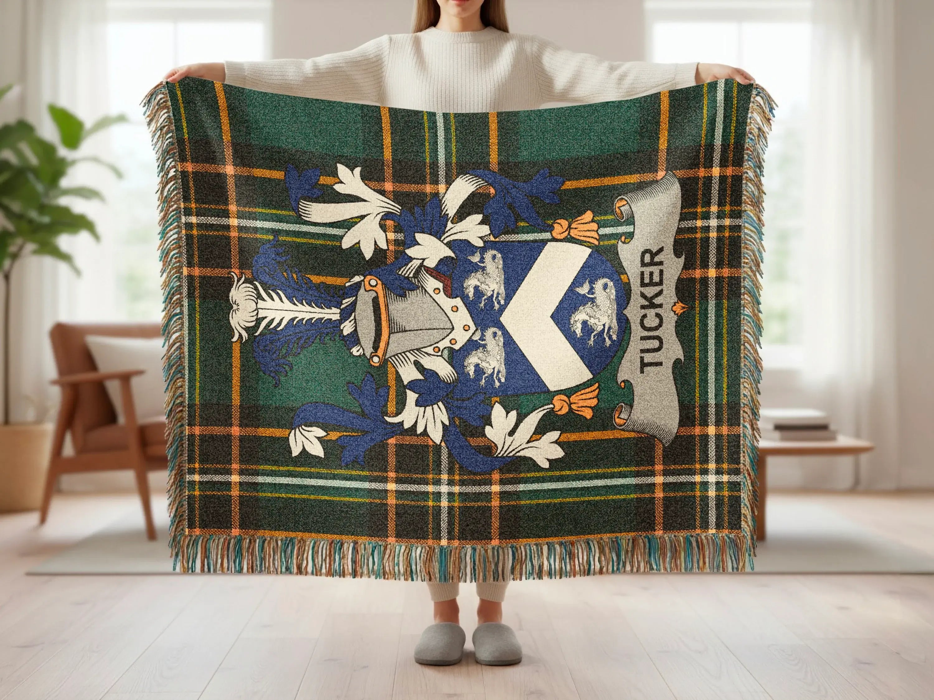 Tartan throw blanket with a shield and "TUCKER" inscription.