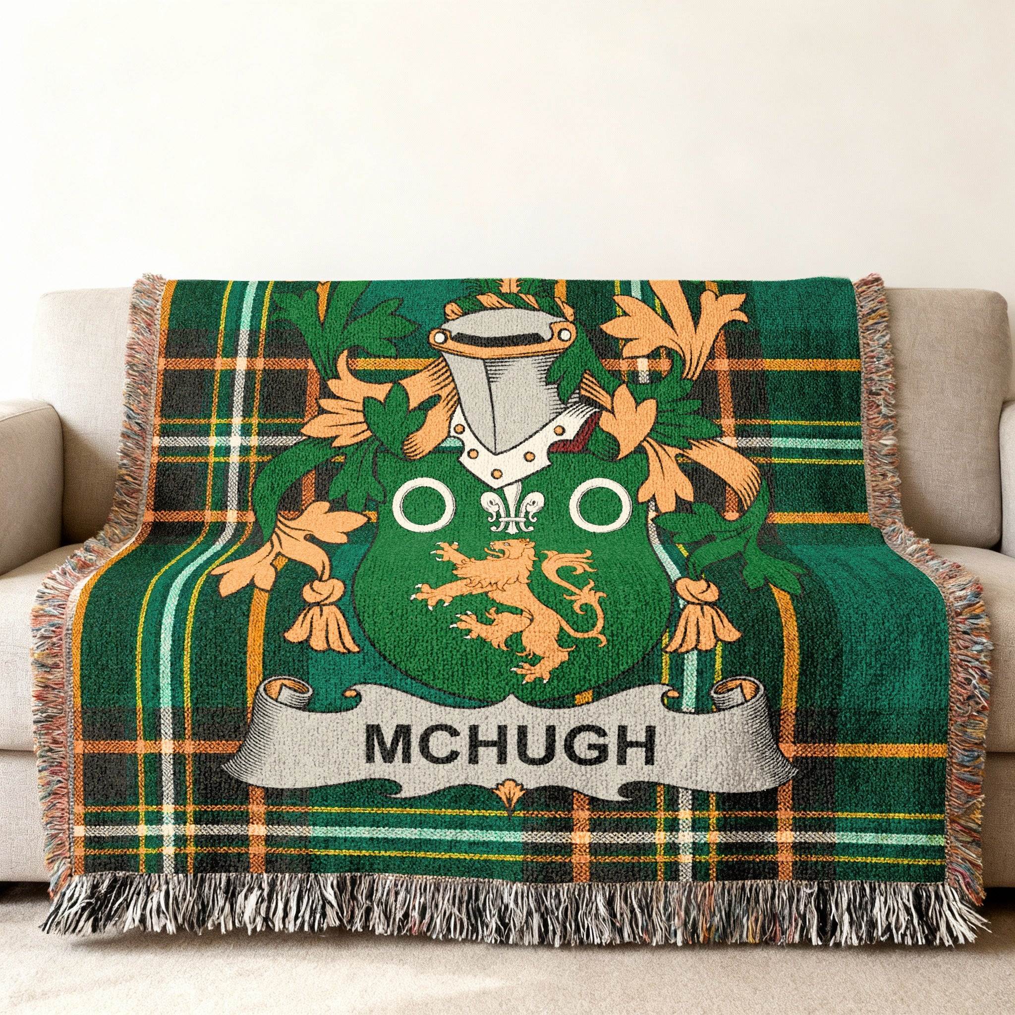 Green plaid throw blanket with McHugh family crest in the center.
