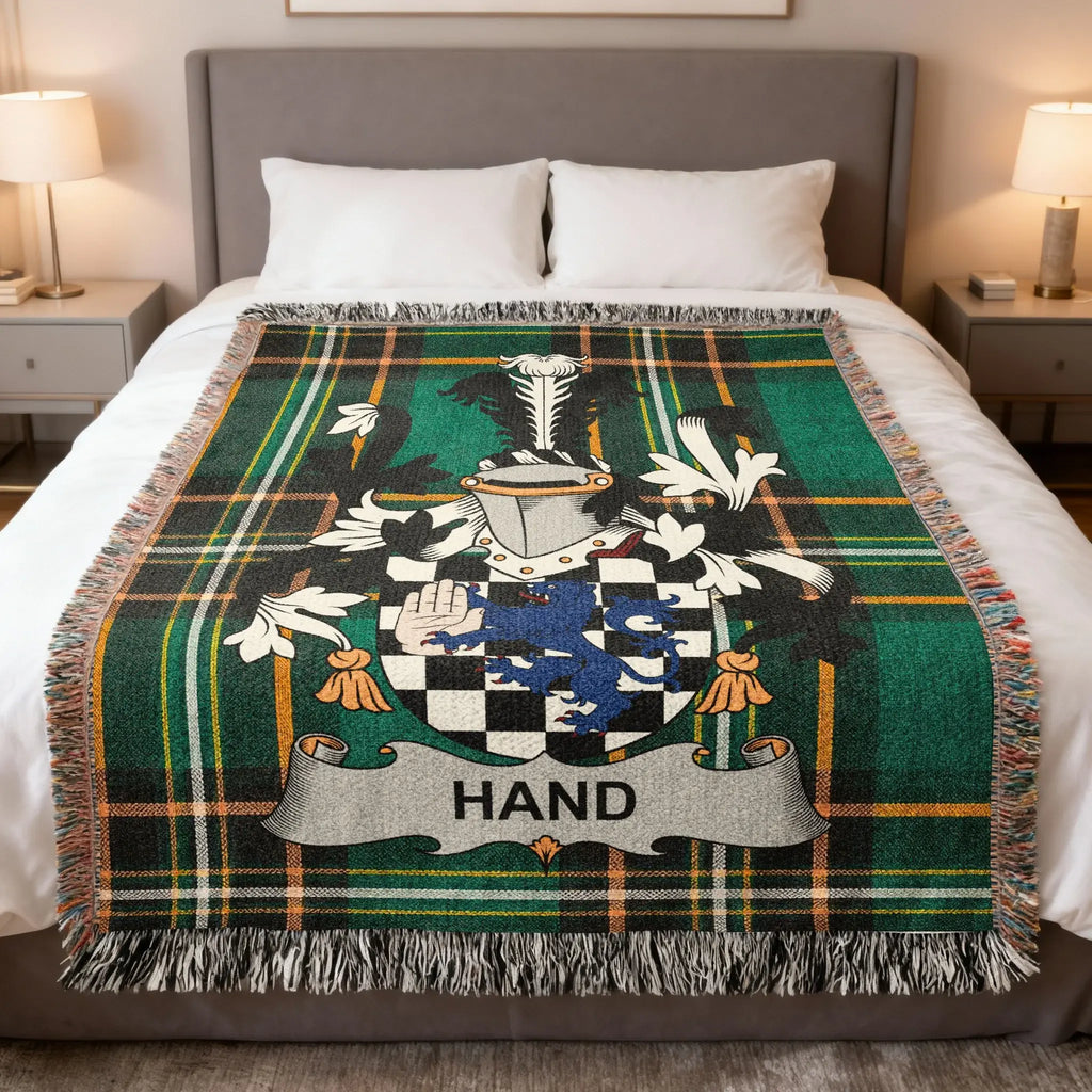Green plaid throw blanket featuring a blue and silver family crest with the name HAND.