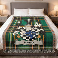 Green plaid throw blanket featuring a blue and silver family crest with the name HAND.