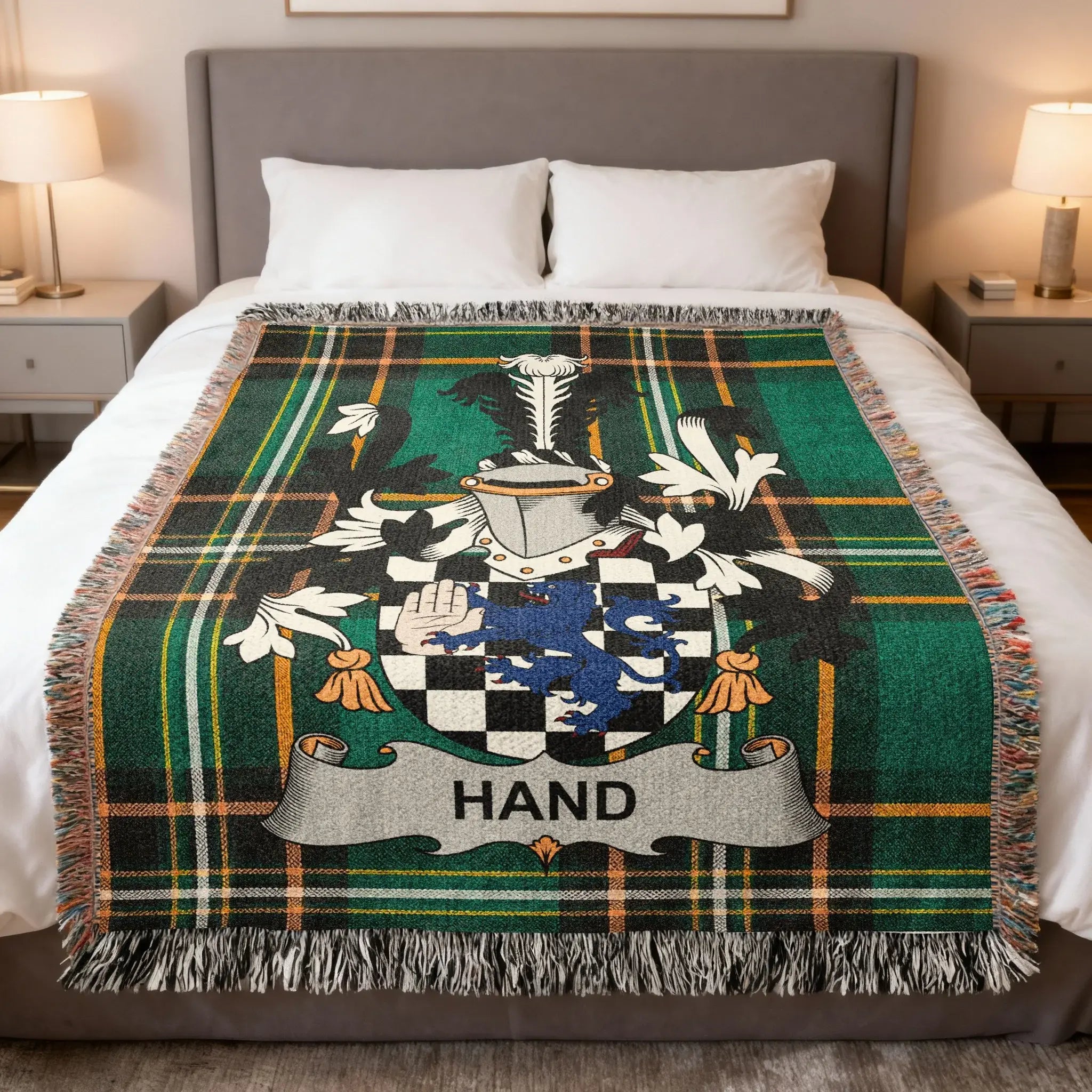 Green plaid throw blanket featuring a blue and silver family crest with the name HAND.