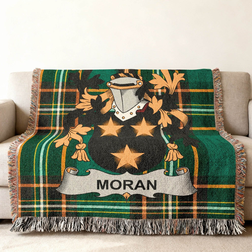 Green tartan blanket with Moran family crest featuring stars and shield.
