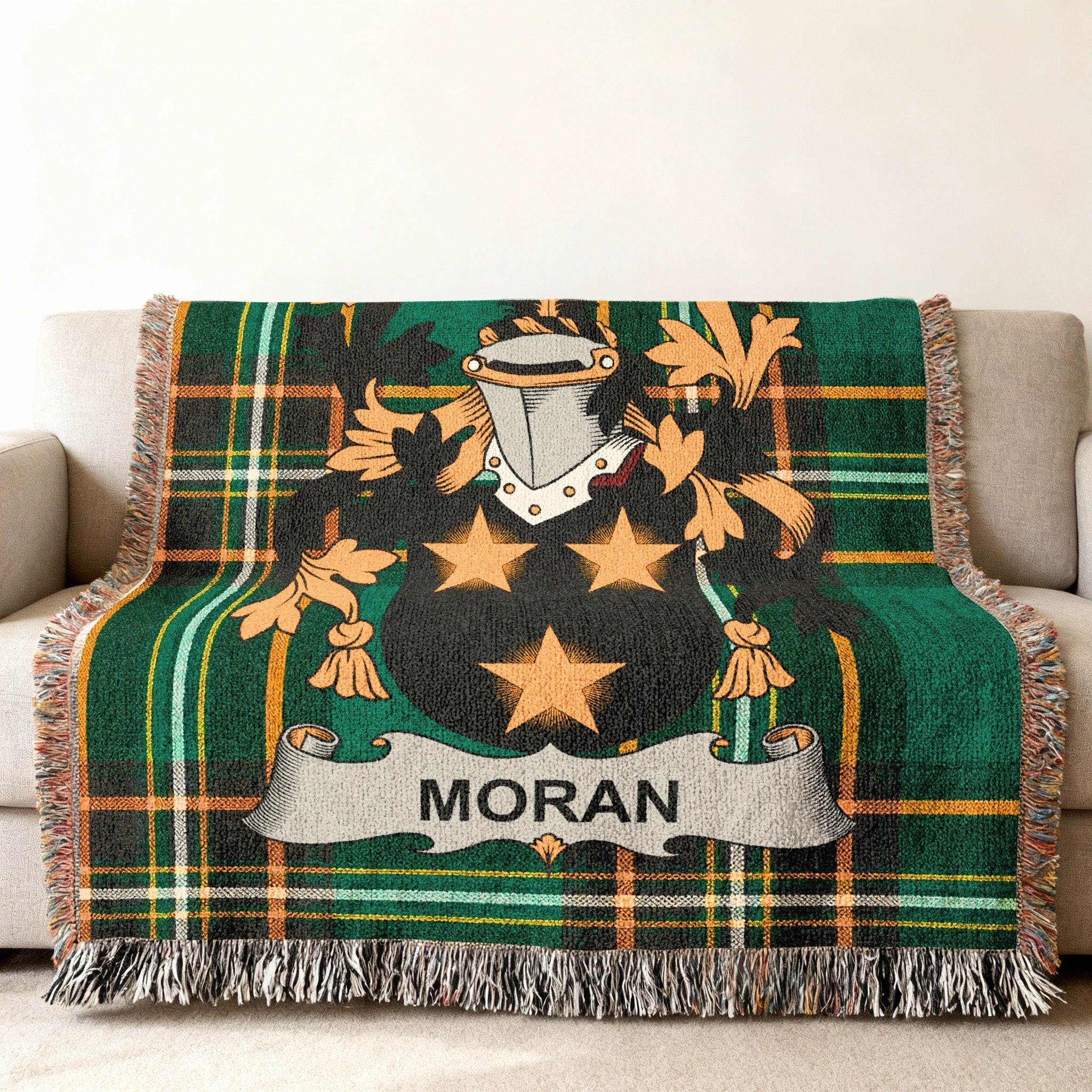 Green tartan blanket with Moran family crest featuring stars and shield.
