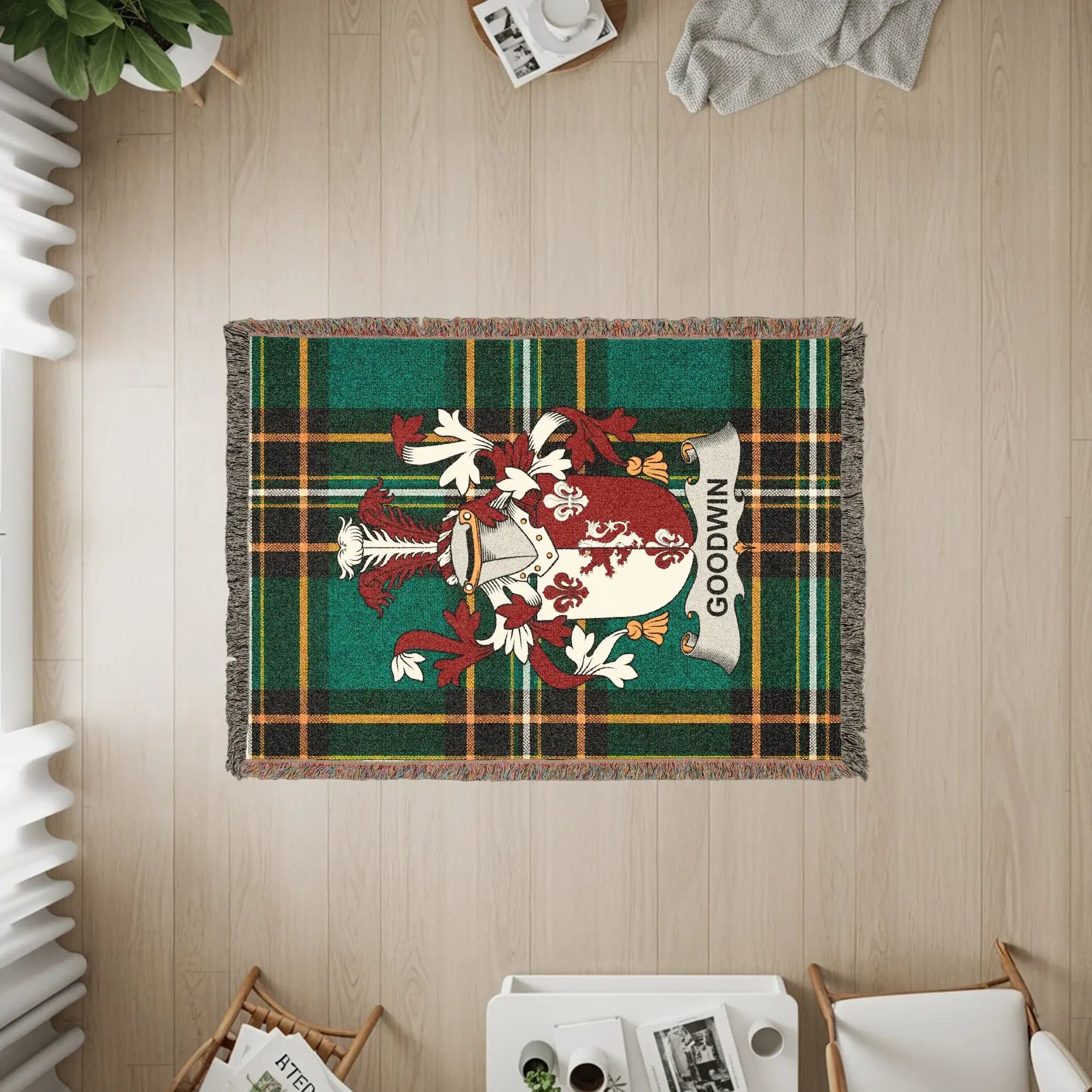Tapestry featuring the Goodwin family crest on a green plaid background.