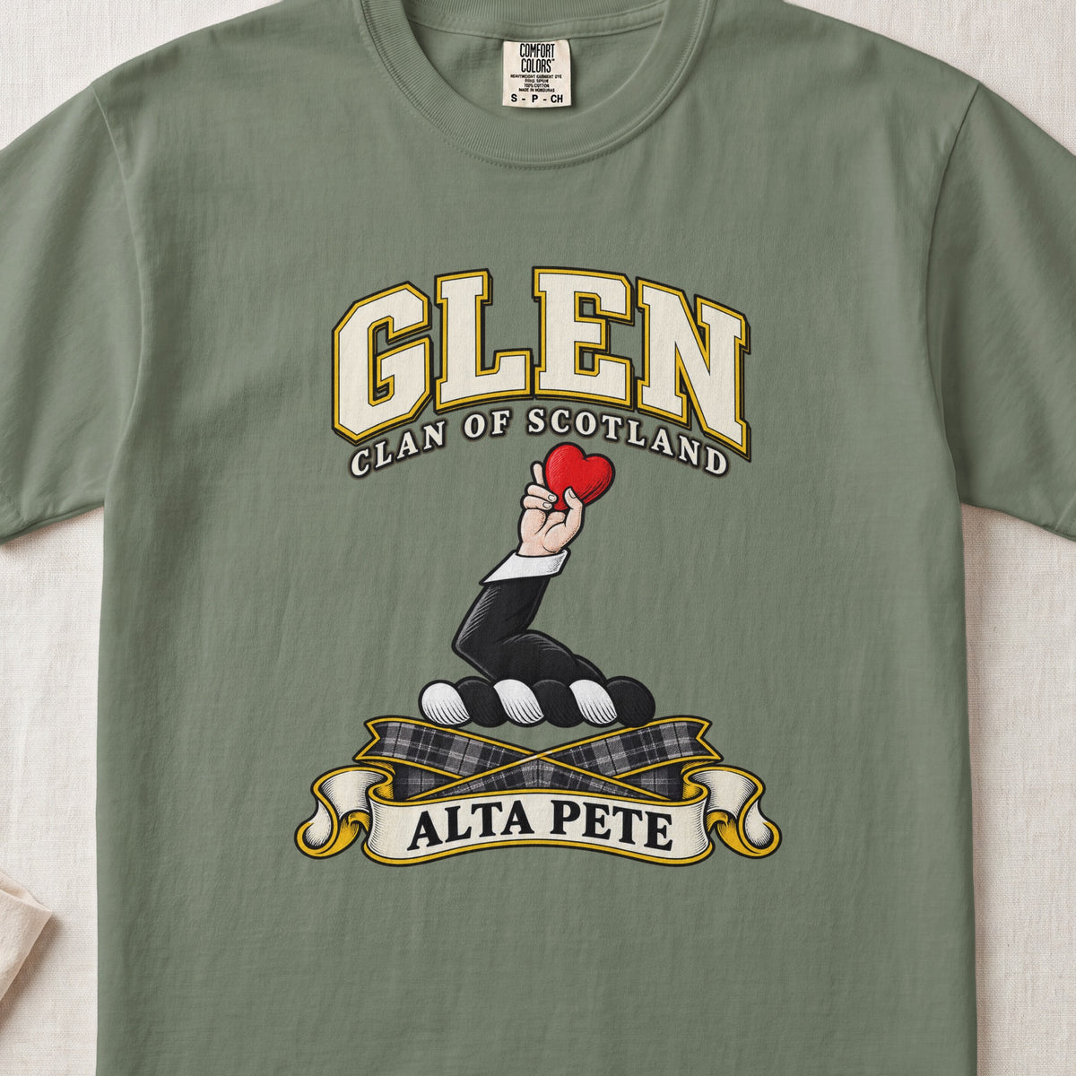 Glen Scottish clan T-shirt in Moss, front view with a hand holding a red heart and motto banner.