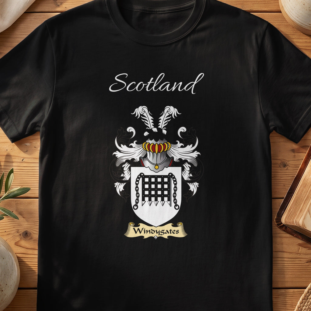 Black Windygates Scottish family crest T-shirt laid flat, showing “Scotland” above a black-and-silver shield featuring a gate-like emblem.