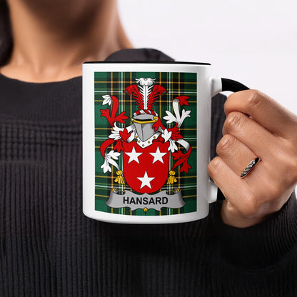 White mug with Hansard family crest on green tartan background.