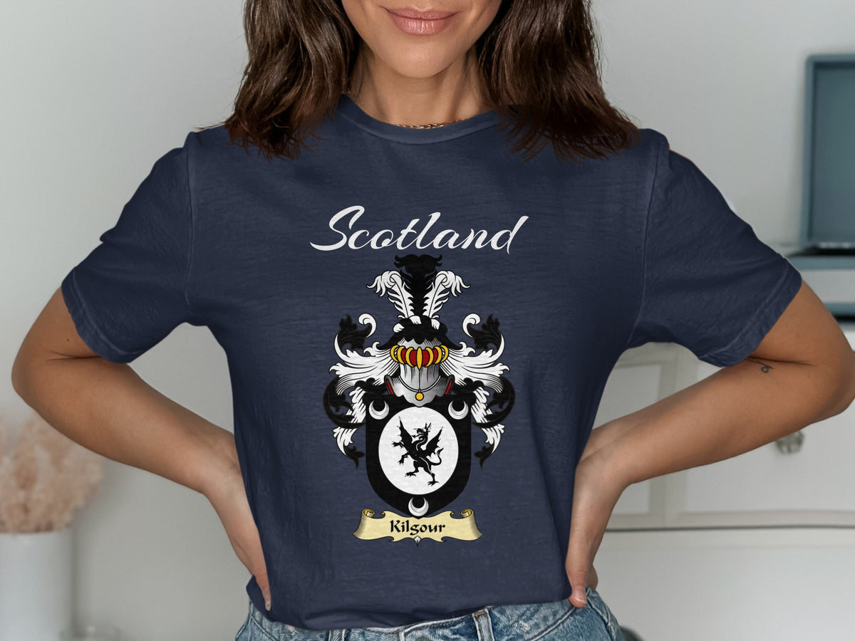 Model wearing a navy Kilgour T-shirt featuring a black winged creature in a white oval