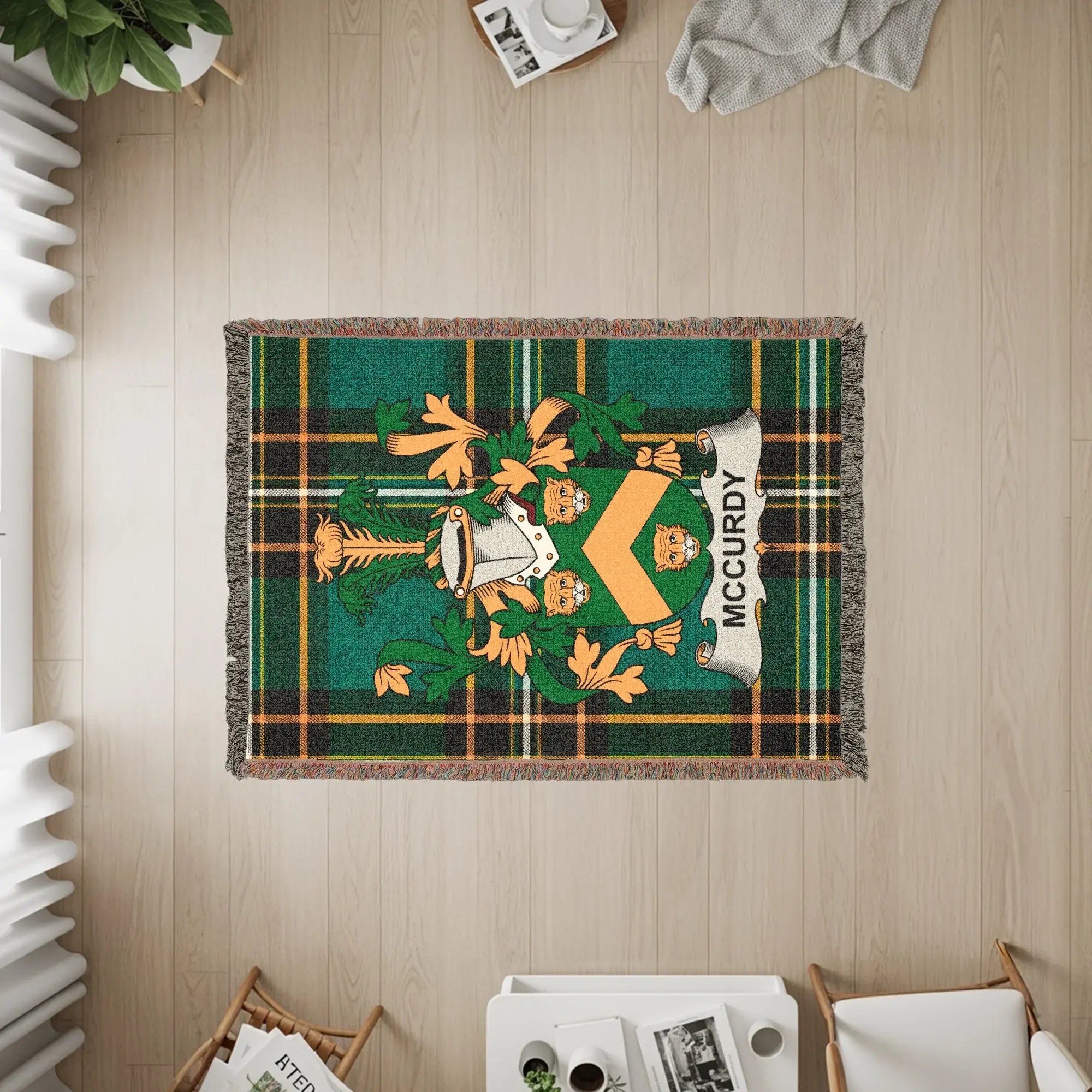 Green plaid woven throw blanket with McCurdy family crest.