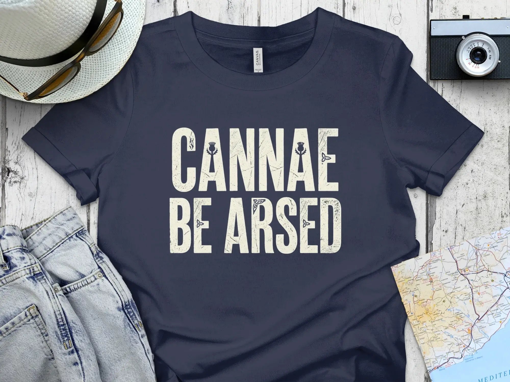 Navy t-shirt with "CANNAE BE ARSED" text and Scottish thistle graphic.