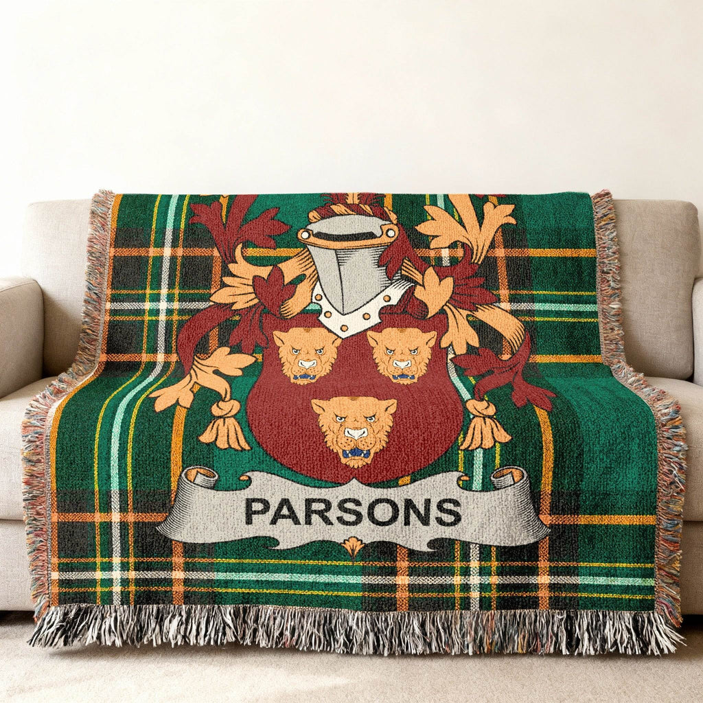 Green plaid throw blanket with a coat of arms featuring three lions and the name "PARSONS."