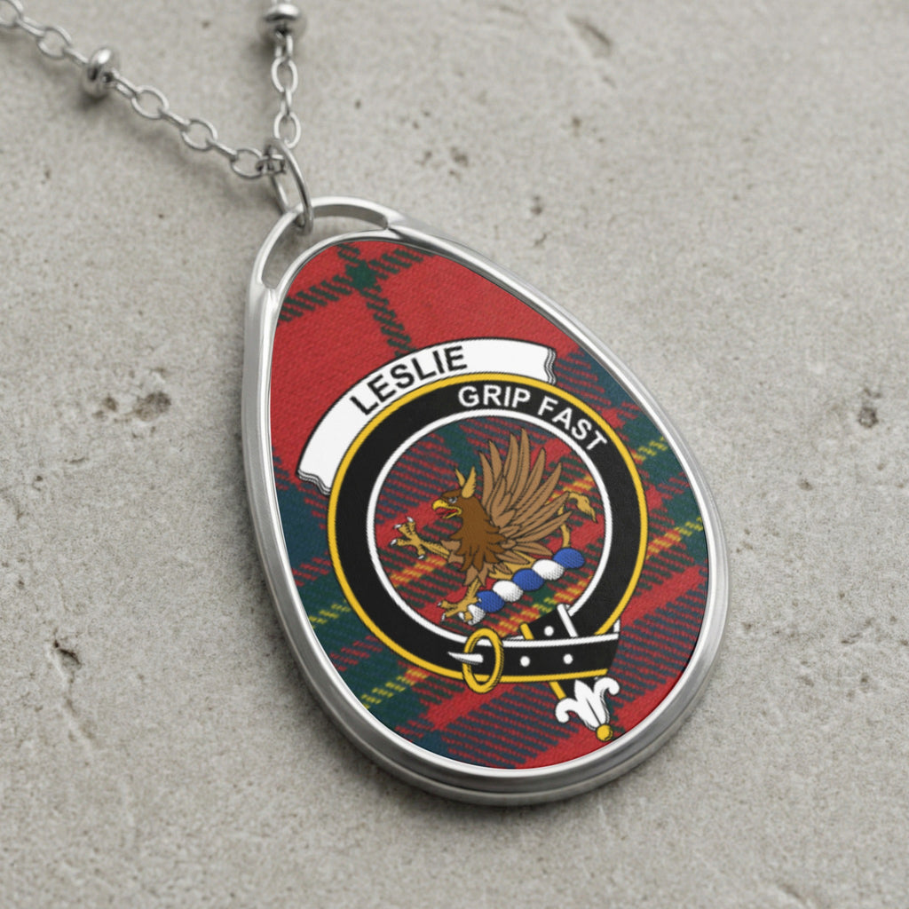 Leslie clan Scottish tartan necklace with clan crest and Grip Fast motto on tartan background
