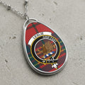 Leslie clan Scottish tartan necklace with clan crest and Grip Fast motto on tartan background
