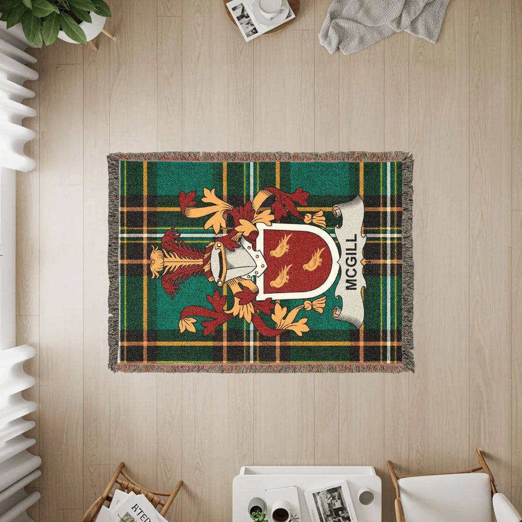 McGill clan crest on a green plaid woven blanket.