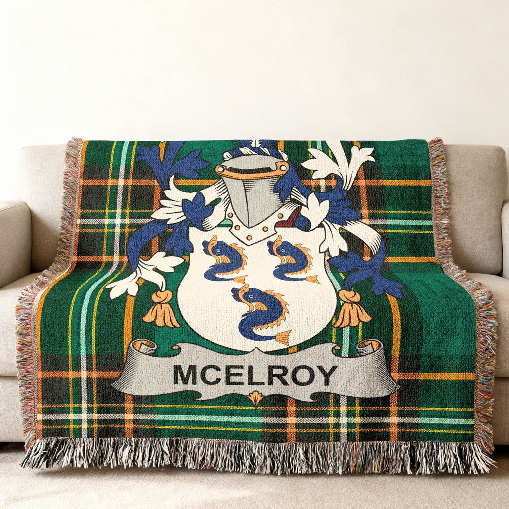 McElroy family crest displayed on a green plaid throw blanket.