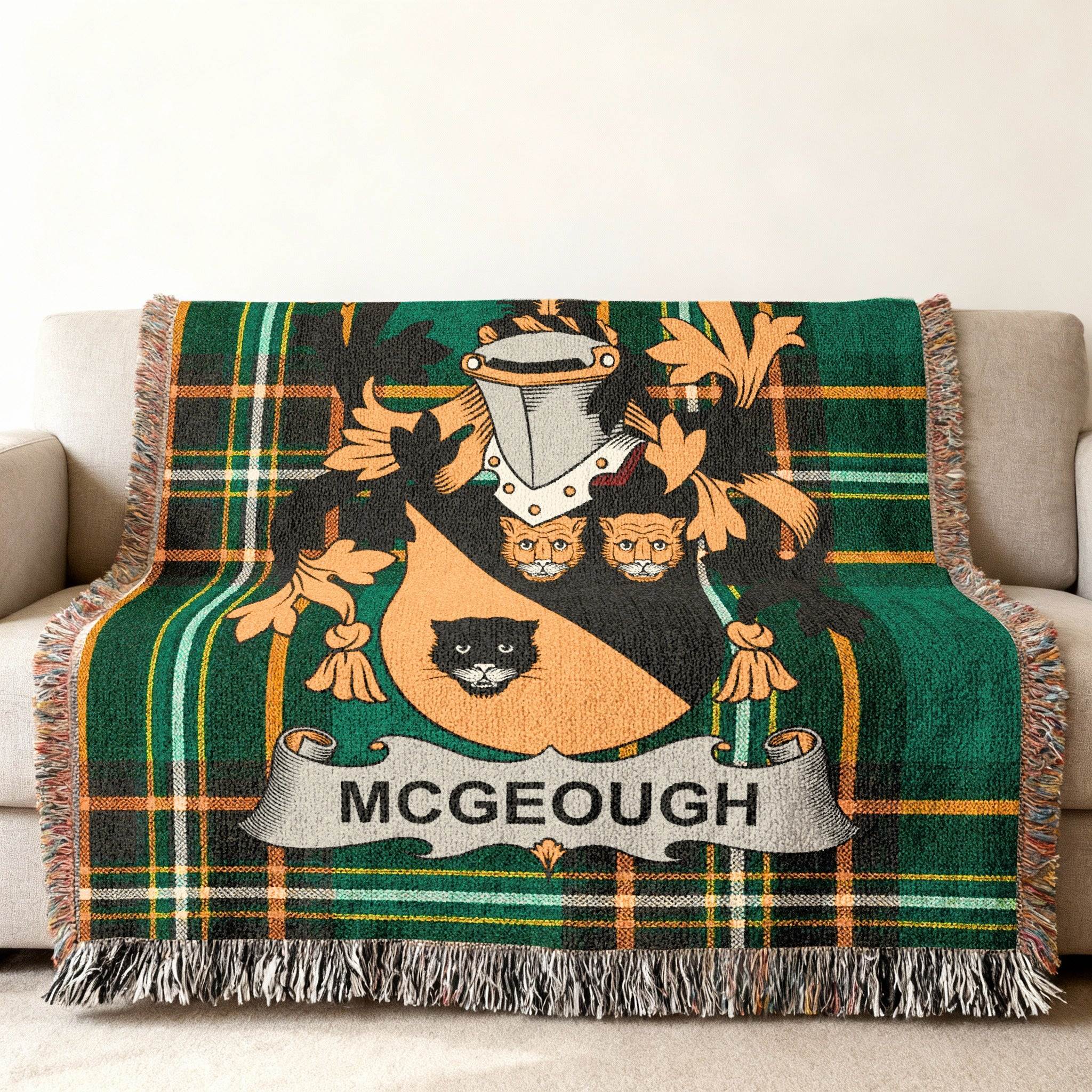 McGeough family crest on a green plaid woven blanket with fringe.