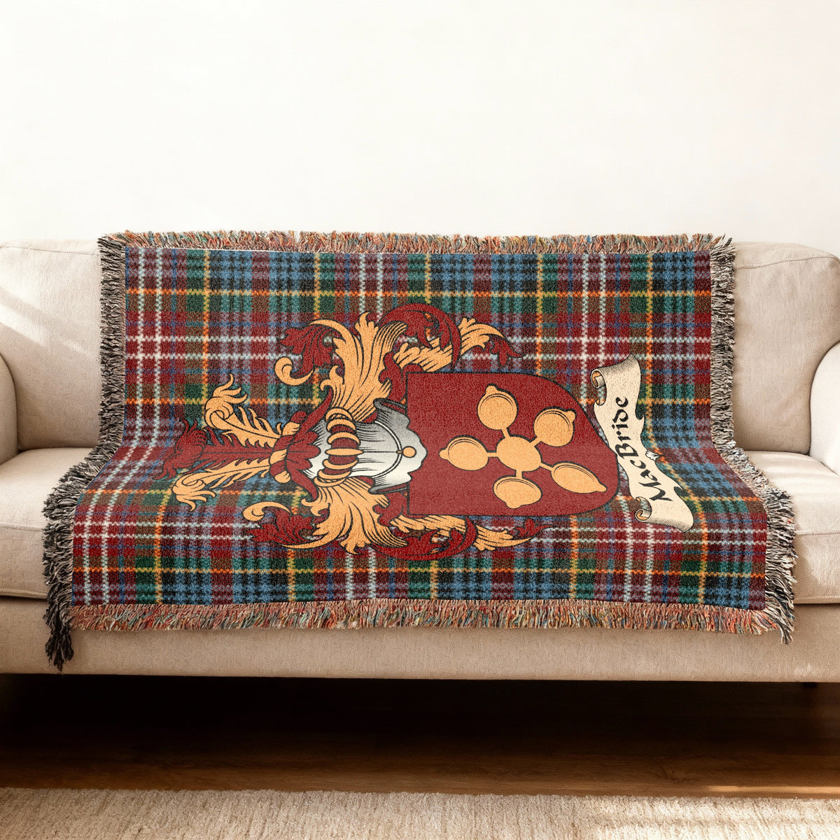 MacBride Scottish woven blanket with family shield and Caledonia tartan background