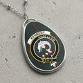 Kennedy clan Scottish tartan necklace with clan crest and Avise La Fin motto on tartan background