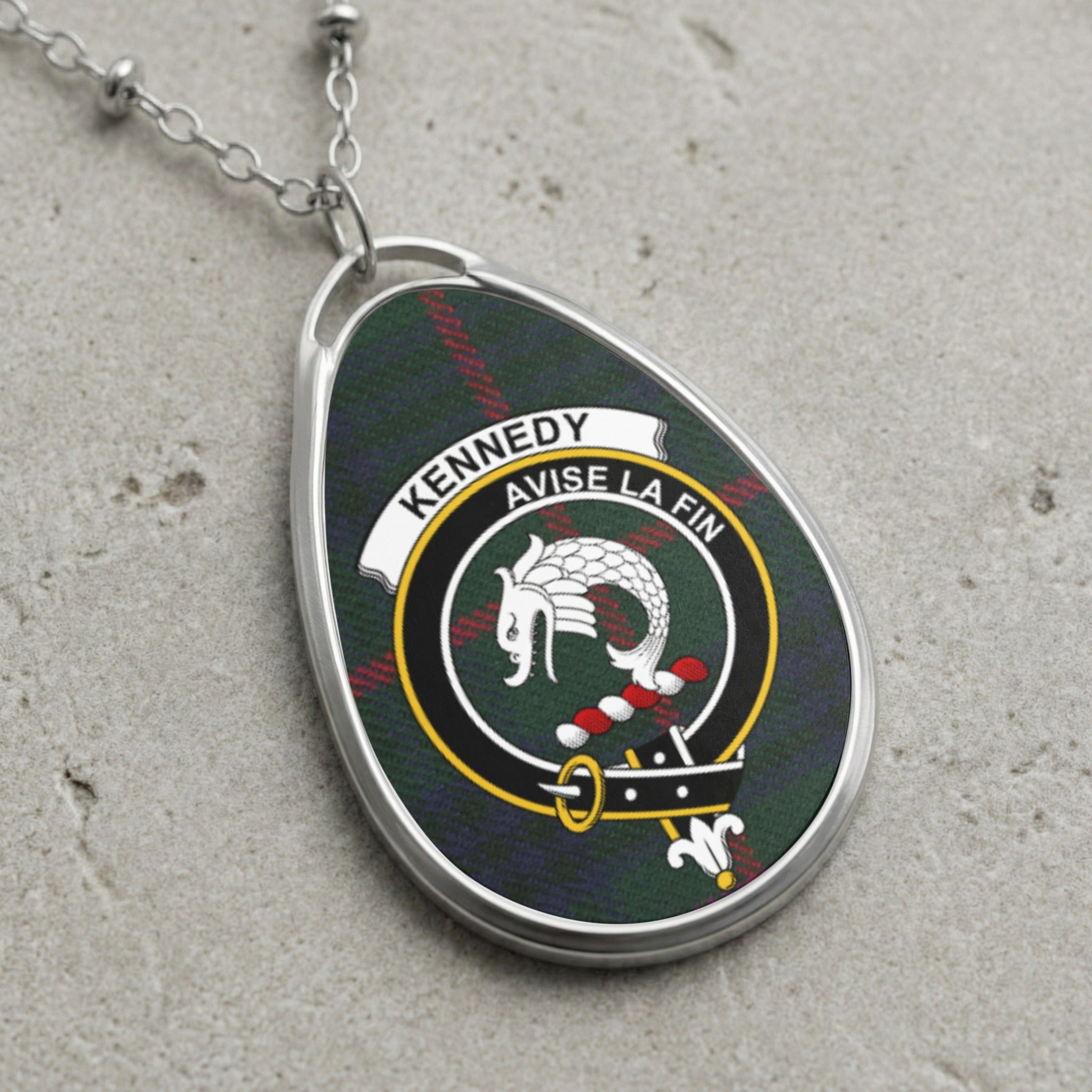 Kennedy clan Scottish tartan necklace with clan crest and Avise La Fin motto on tartan background