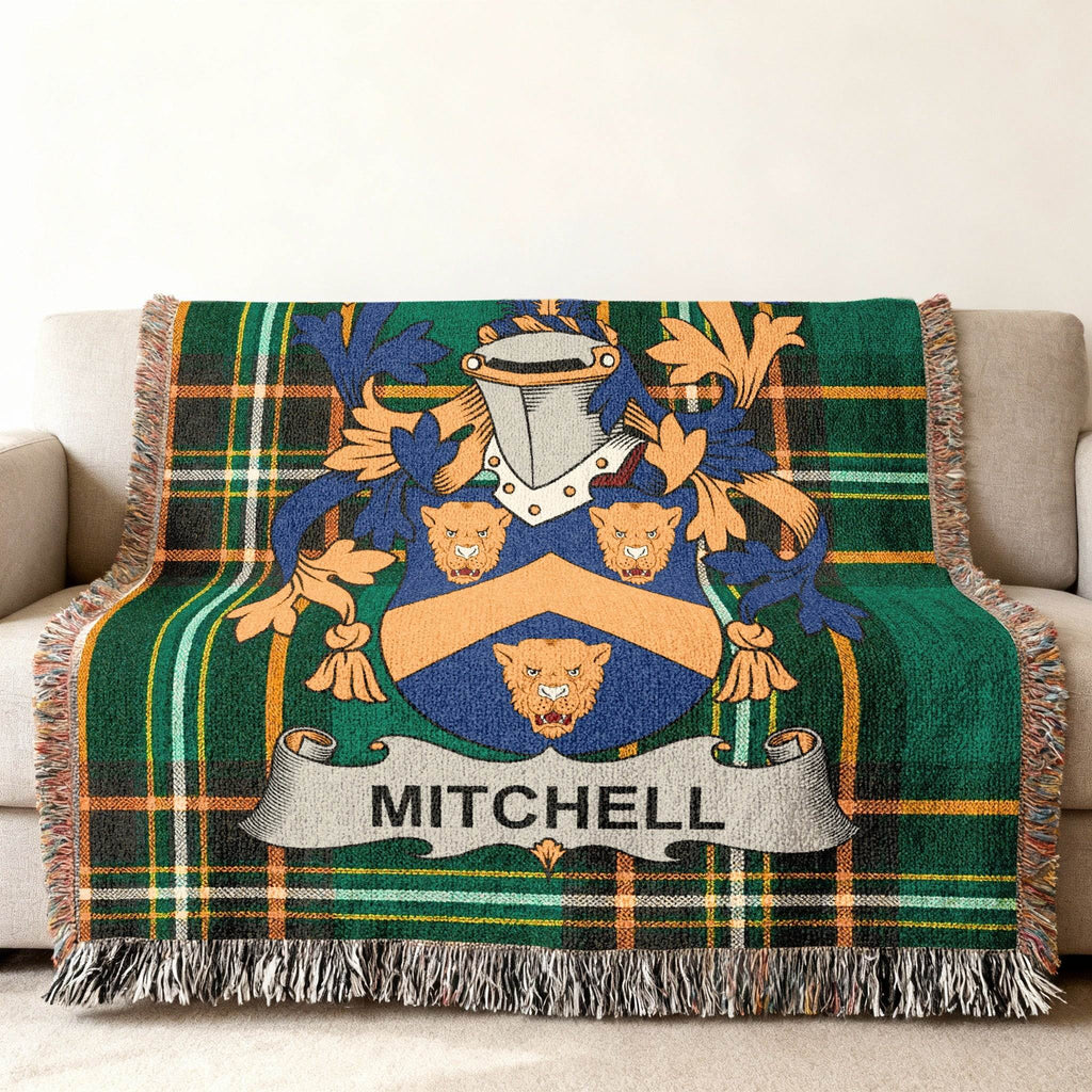 Green plaid throw blanket with Mitchell family crest.
