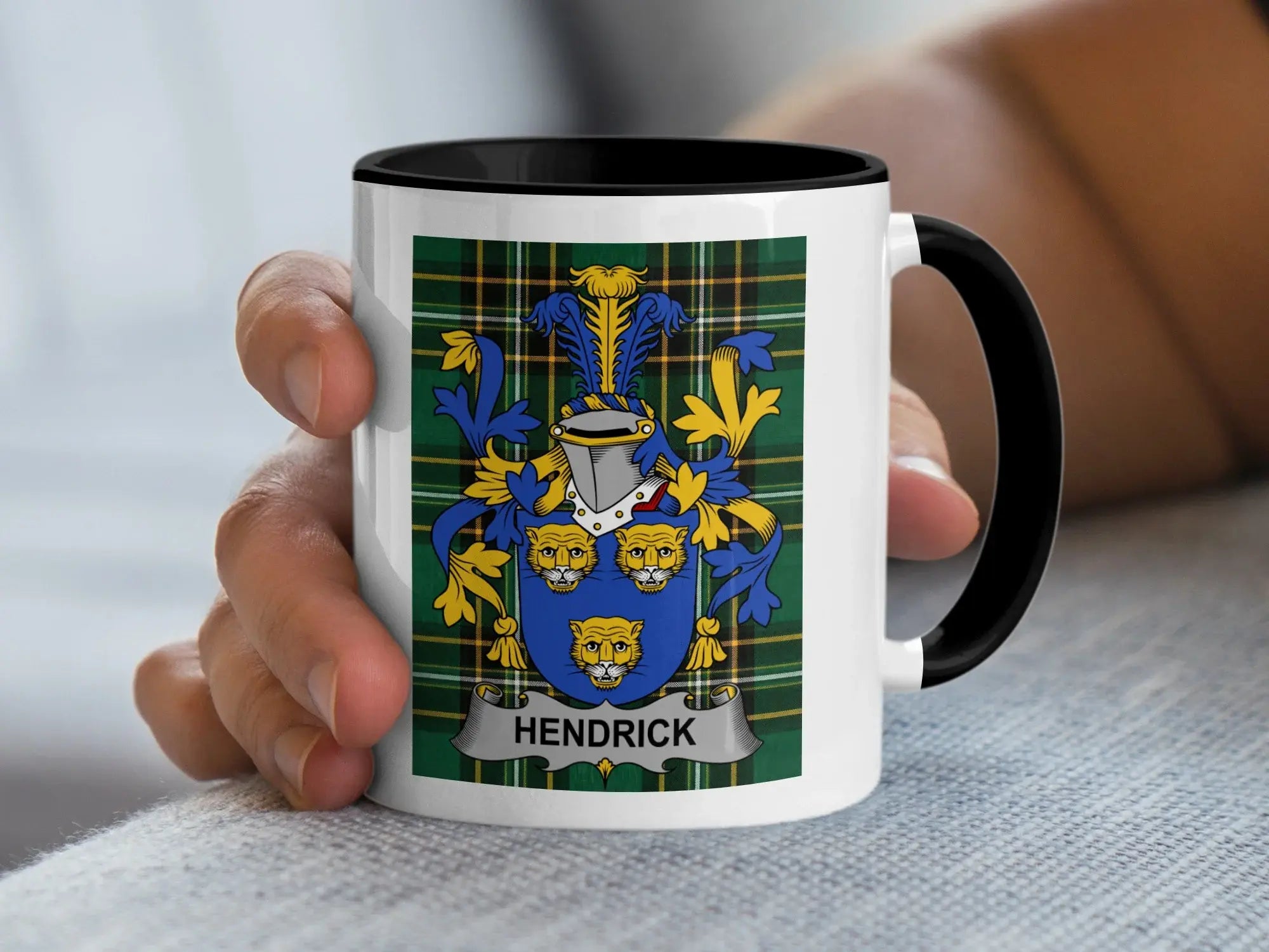 Mug with black rim featuring the Hendrick family crest on a tartan background.
