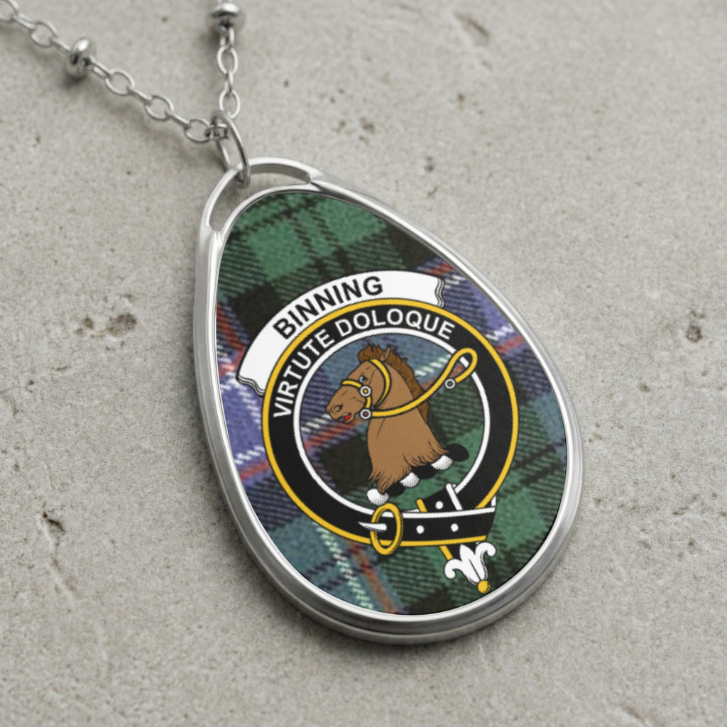 Binning clan Scottish tartan necklace with clan crest on tartan background