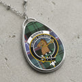 Binning clan Scottish tartan necklace with clan crest on tartan background