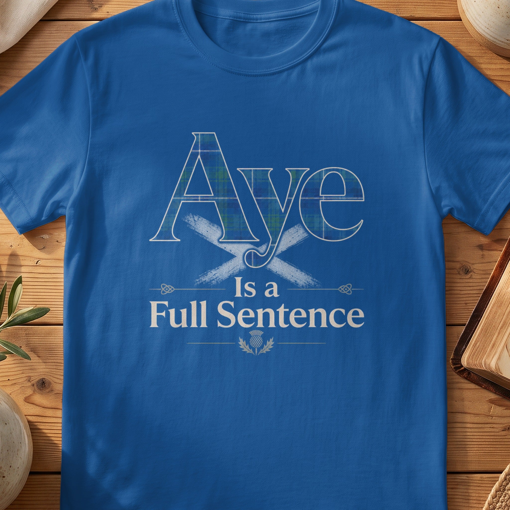 Royal blue t-shirt with "Aye Is a Full Sentence" in plaid and white text.