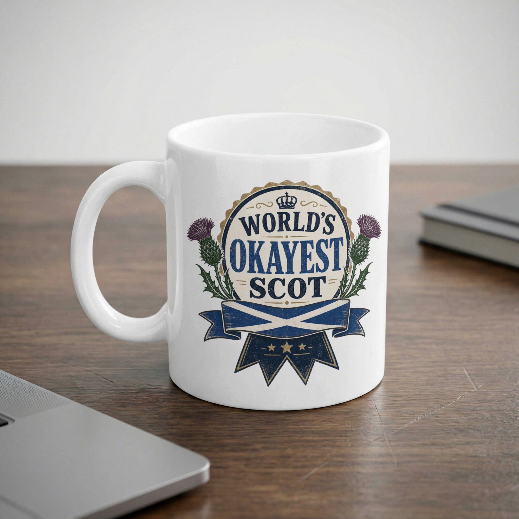 White mug with "World's Okayest Scot" text and thistle graphic.