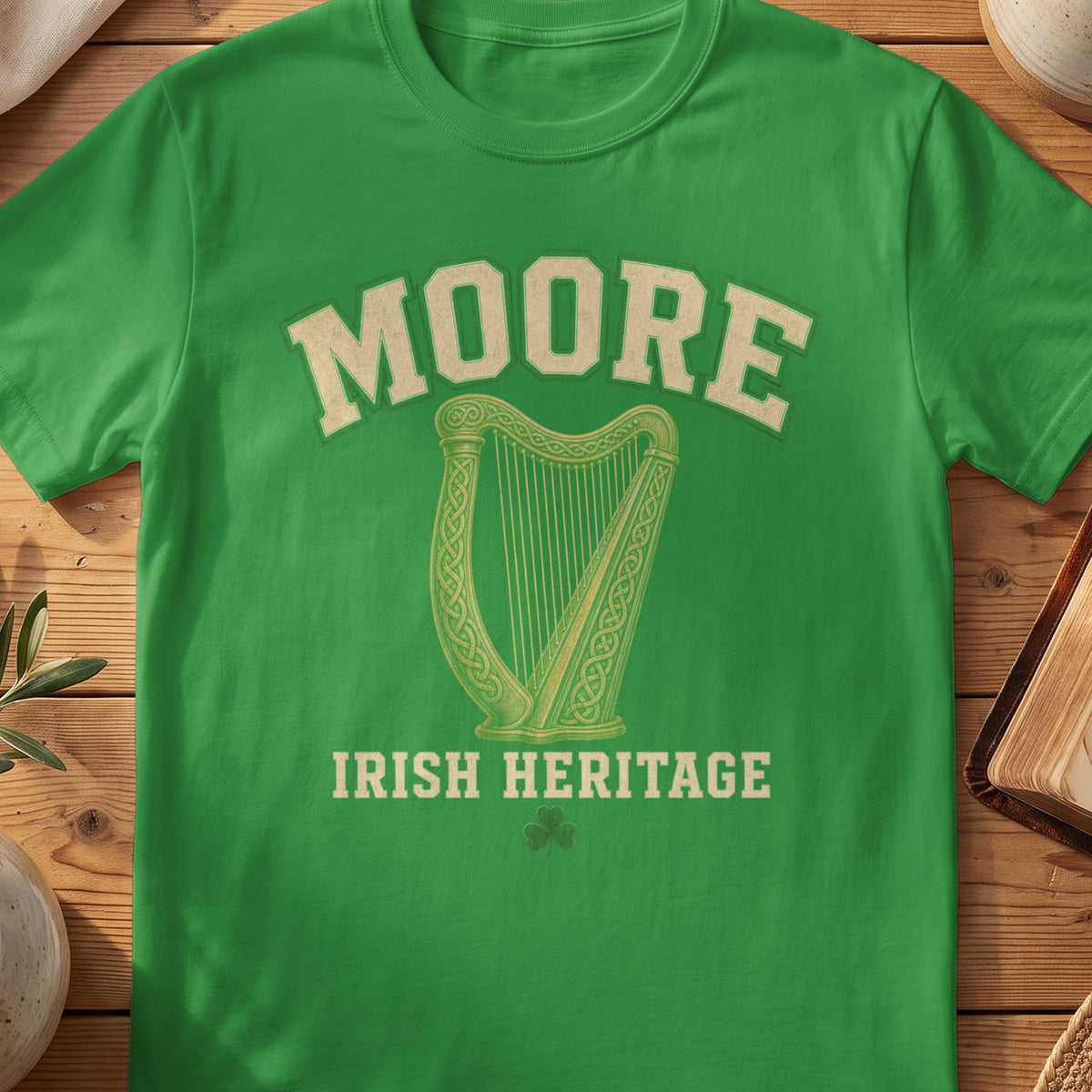 Moore Irish harp T-shirt in Irish Green, with cream surname lettering, a gold-toned harp, green shamrock and “Irish Heritage” text.