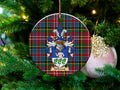 Kirkwood Scottish clan ceramic ornament with family crest on a Caledonia tartan background, hanging on a Christmas tree