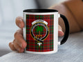 Cairns Scottish family crest artwork on an 11 oz black accent mug with a tartan background