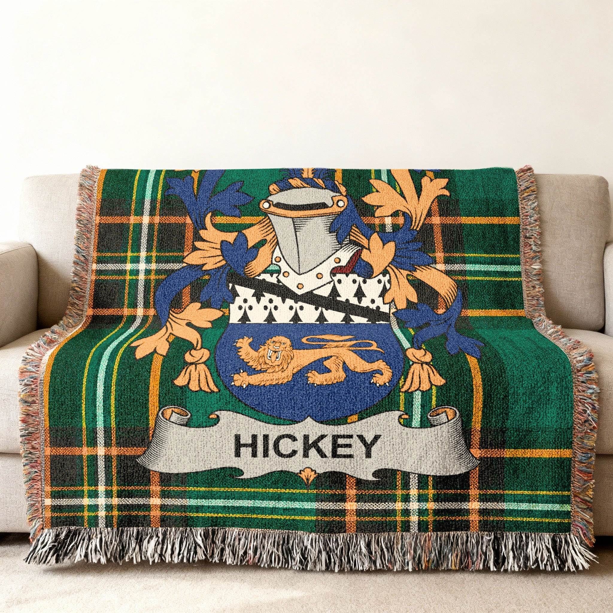 Woven blanket with green plaid and Hickey family crest.