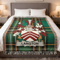 Green plaid blanket with Langton family crest displayed on a bed.