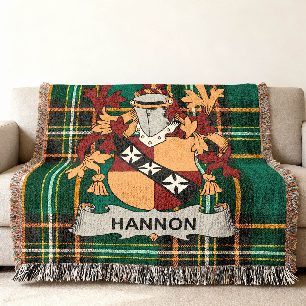 Green tartan blanket with HANNON family crest draped on sofa.
