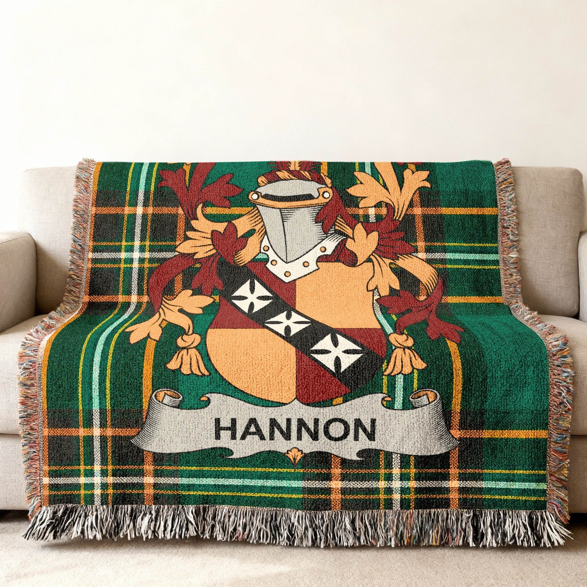 Green tartan blanket with HANNON family crest draped on sofa.