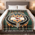 House of MacCann family crest woven blanket on an Irish National Tartan background, displayed on a bed