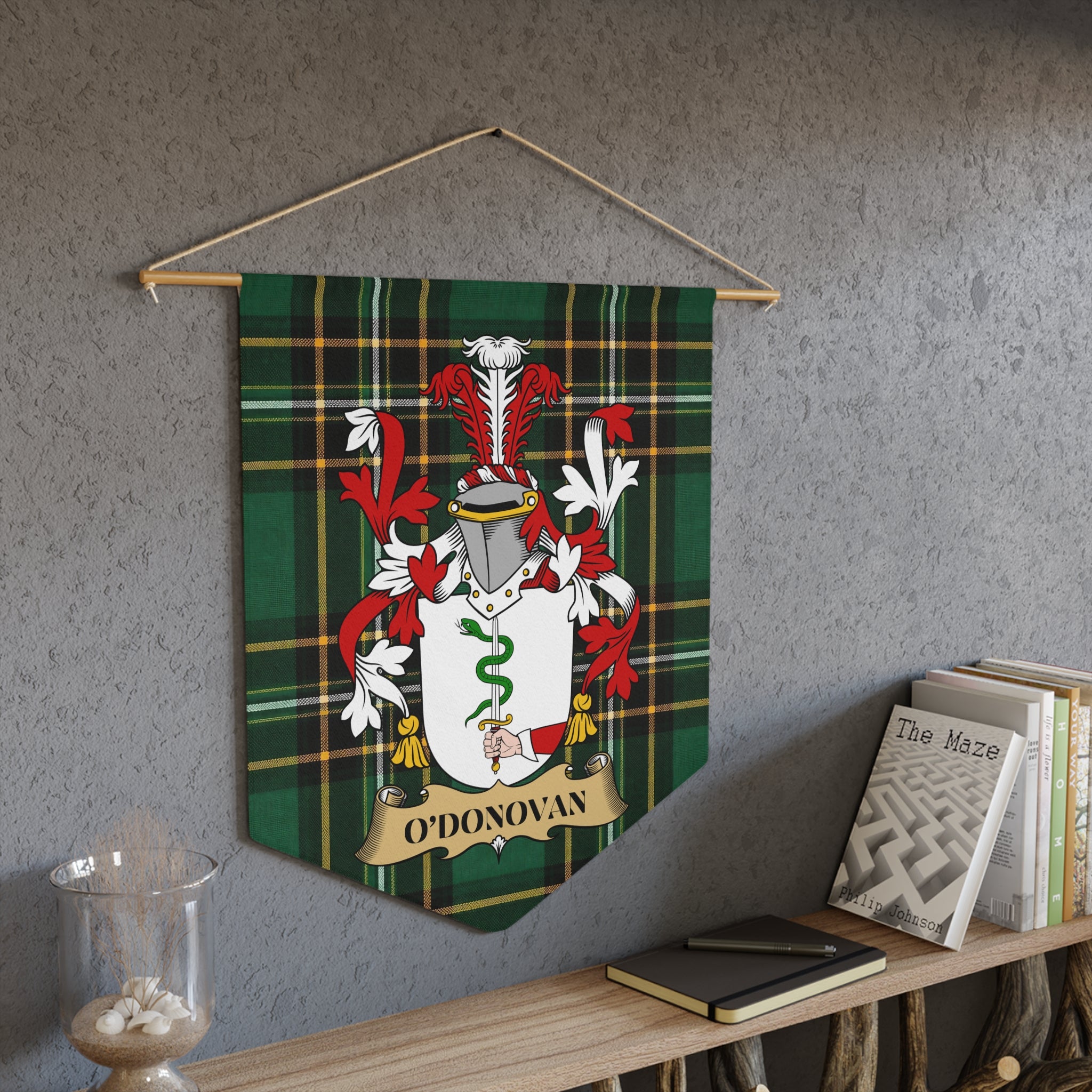 O'Donovan family crest on green tartan pennant hanging on a wall.