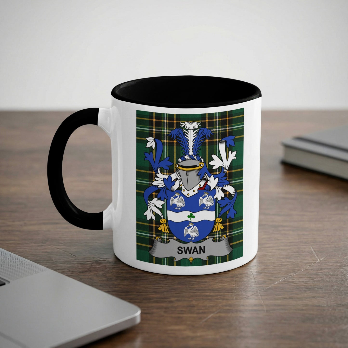 White mug with black handle featuring the Swan family crest on a plaid background.