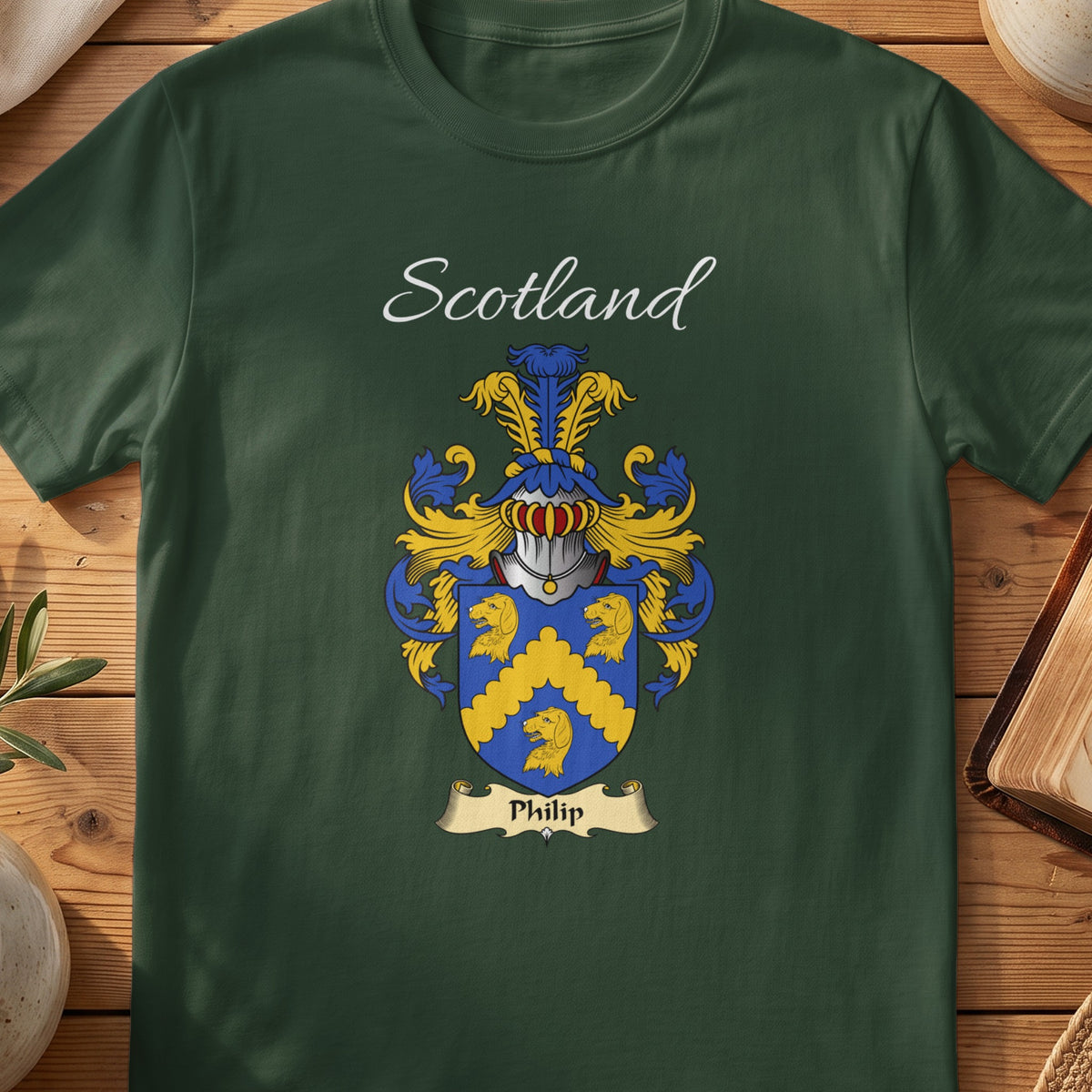 Forest Green Philip Scottish T-shirt laid flat with coat of arms artwork and “Scotland” text.