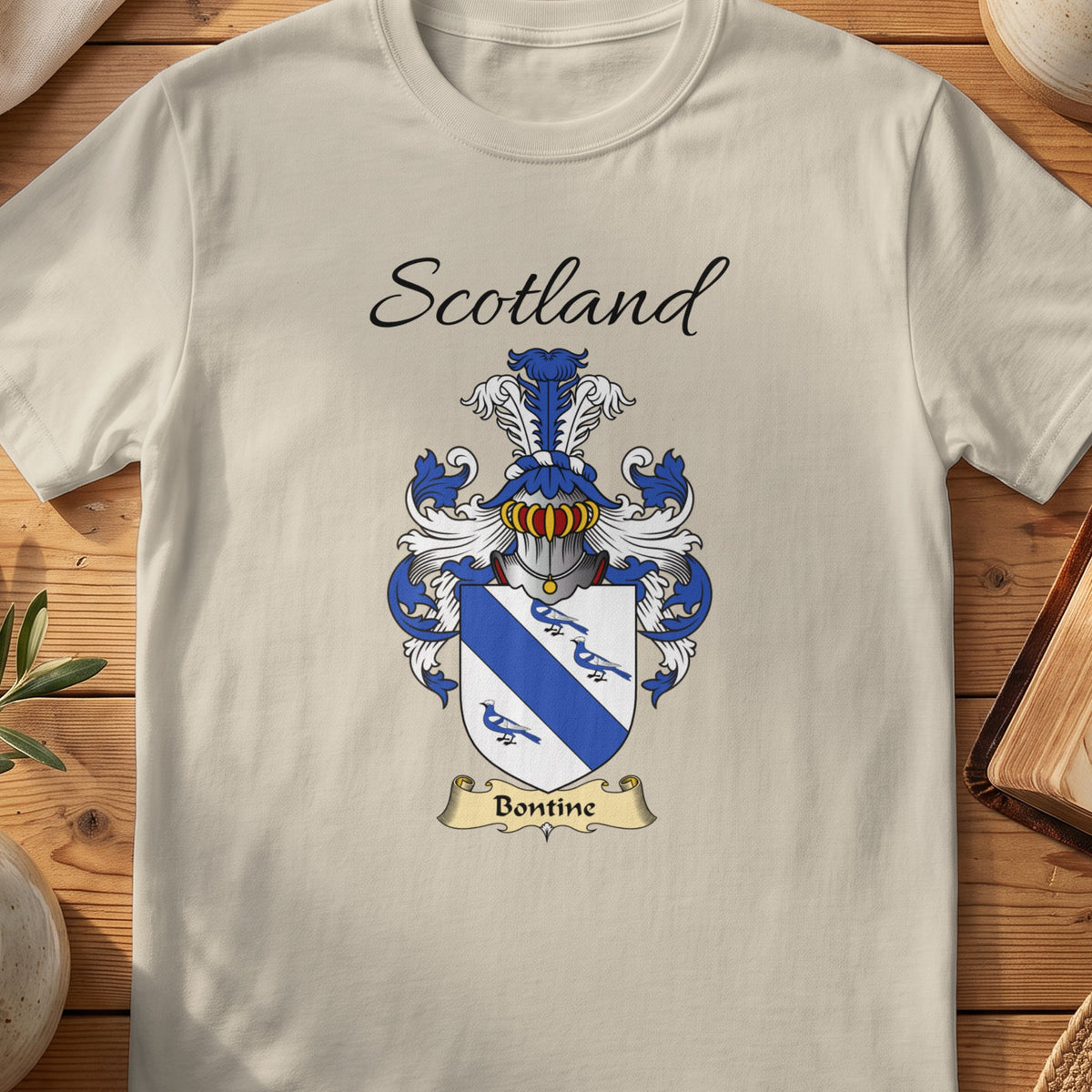Sand Bontine Scottish family shield T-shirt featuring a blue diagonal band and small blue bird motifs