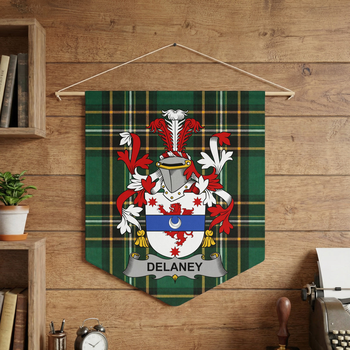 Delaney family crest displayed on a green plaid pennant against a wooden background.