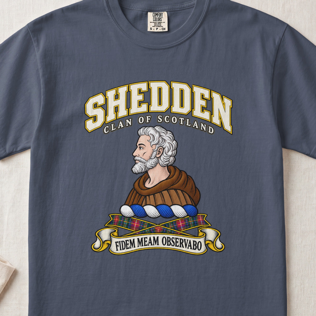 Shedden Scottish clan T-shirt in Midnight, front view with a gray-haired, bearded figure in a brown robe and motto design.