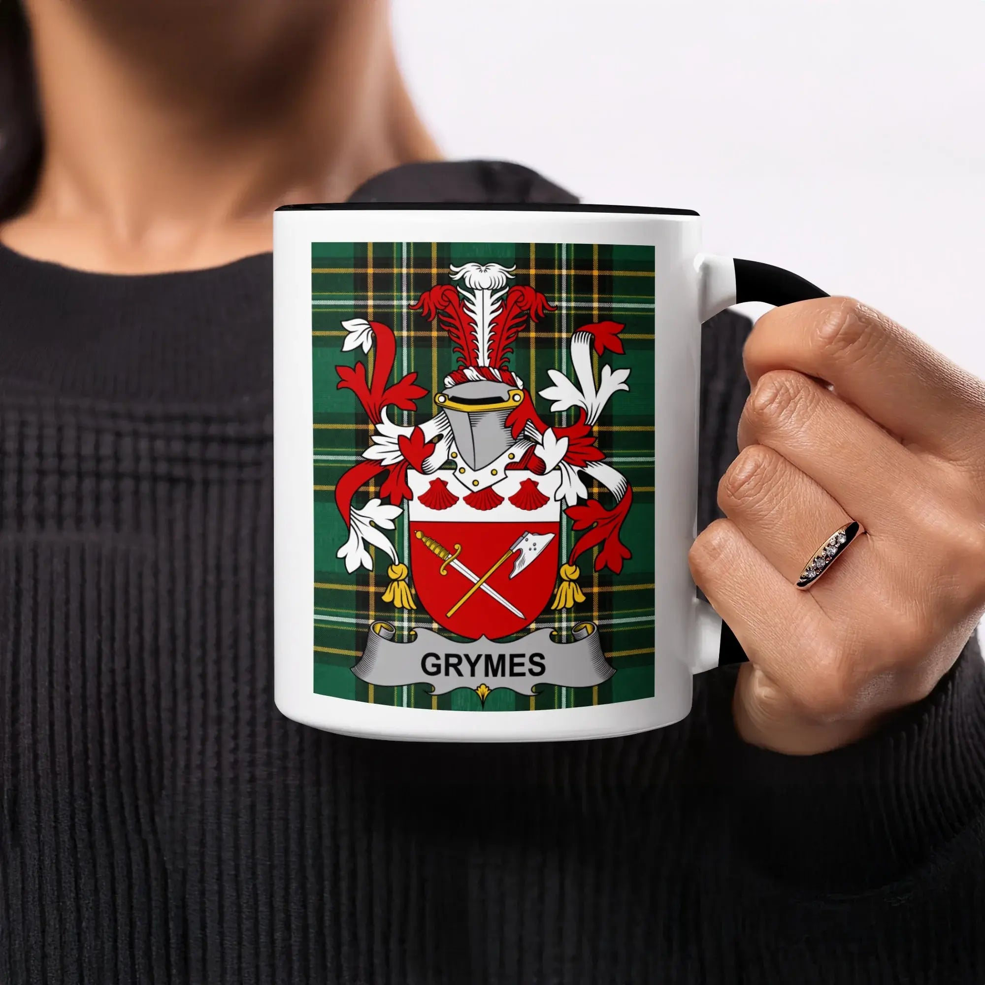 White mug with a Grymes family crest on a tartan background.