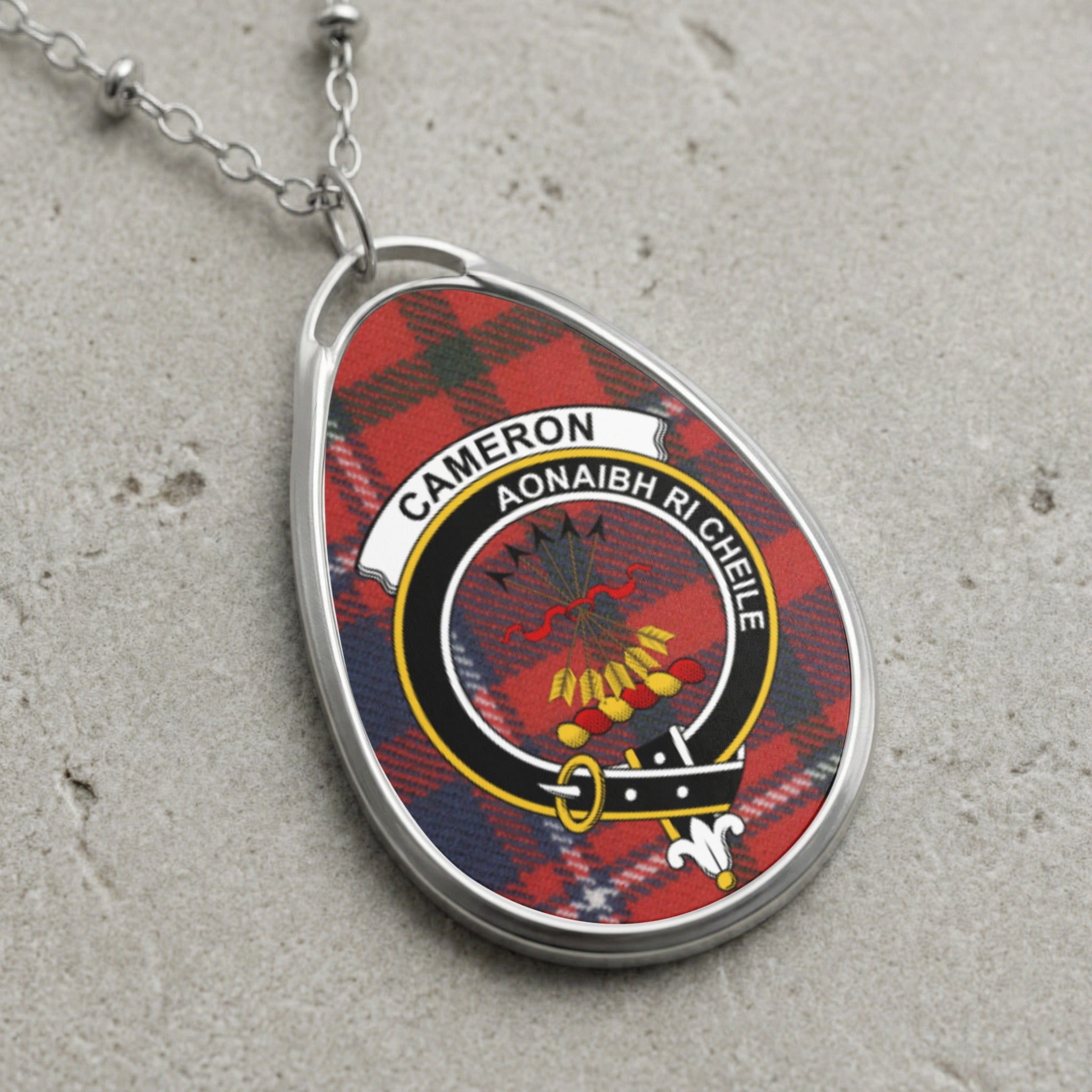 Cameron clan Scottish tartan necklace with clan crest and Aonaibh Ri Cheile motto on tartan background