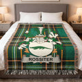 Green tartan blanket with white Rossiter family crest.
